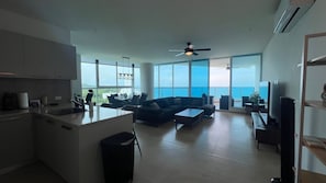 A modern living space with a kitchen, dining area, and seating area with a view of the ocean. - Stunning mountain ocean view 2 beds 2 baths Gorgona (Nueva Gorgona)