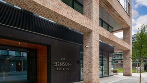 A modern building with a prominent entrance labeled 'The Benson Building.' - Apex Executive Apartments - The Benson (Dublin)