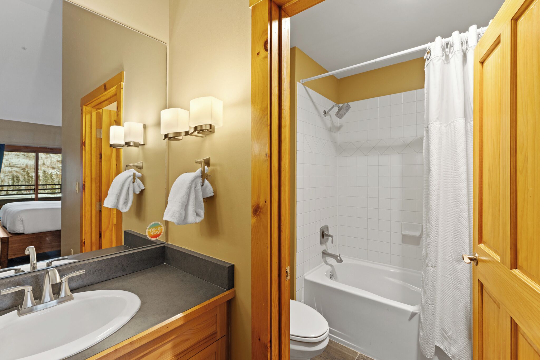 A bathroom with a double sink, a bathtub, and a shower.