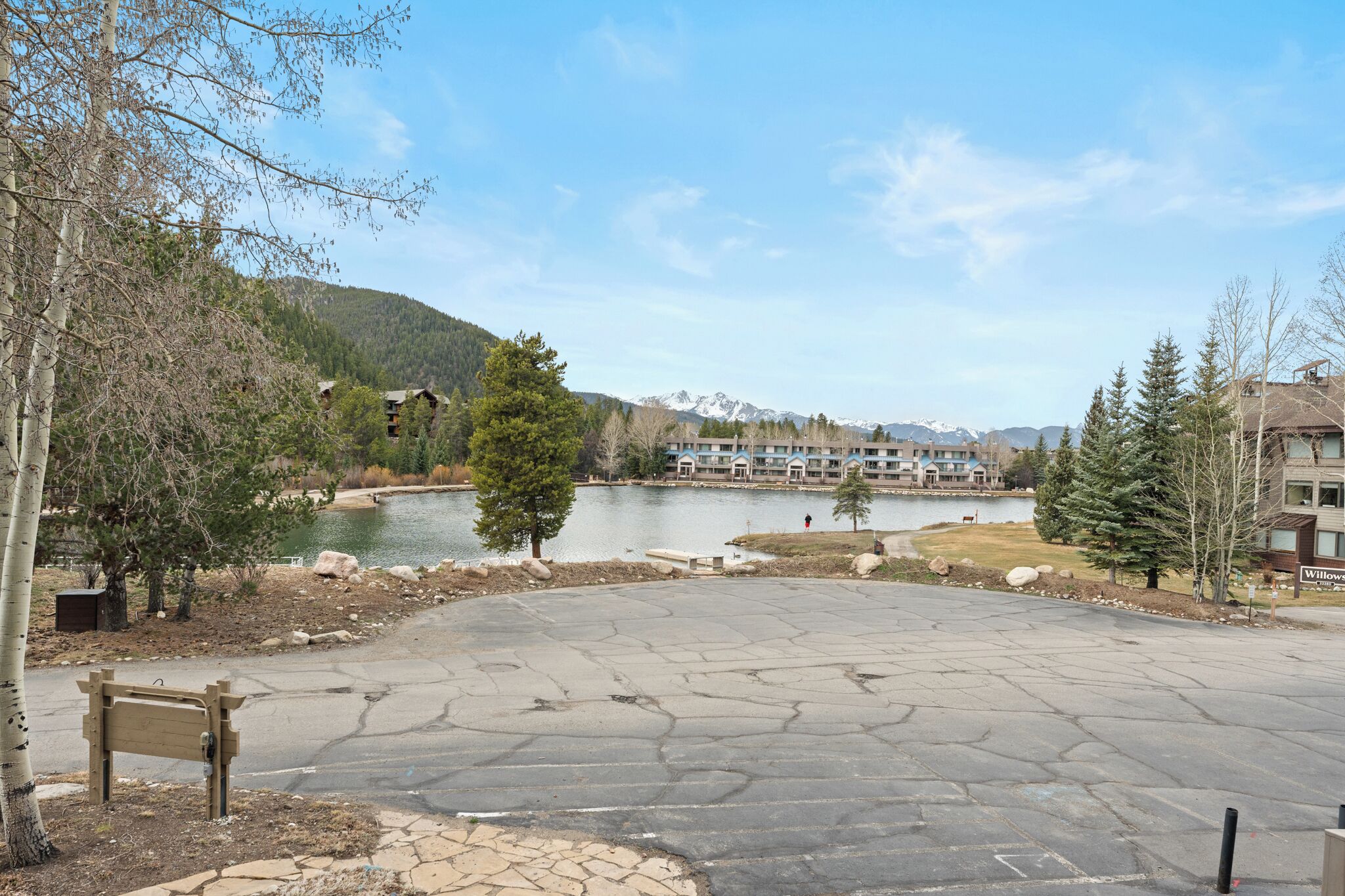 A lakeside view with a paved area, trees, and a building labeled 'Willows.'