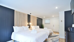 A hotel room with two beds, a wooden panel wall, a large window, and a refrigerator. - Double Room - 2 Queen Beds - Pool View (Himrod)