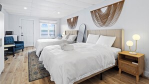 A modern hotel room with two beds, a desk, a chair, and a view of the sea. - Double Room - 2 Queen Beds - Lake View (Himrod)