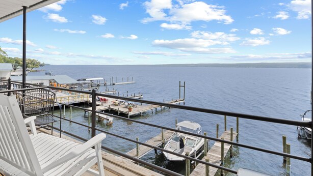 A view from a balcony overlooking a marina with boats docked, a dock, and a clear sky. - Single Room - 1 Queen Bed -Valley View (Himrod)
