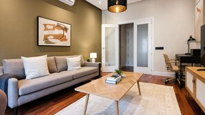 Una sala de estar moderna con un sofá, una mesa de centro y un cuadro en la pared.