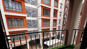 A multi-story building with balconies, a flat roof, and a view of the surrounding area. - Unimash Homes Kenya Great Space W/SwimmingPool Open For Long/Short Term Stays. (Nairobi)