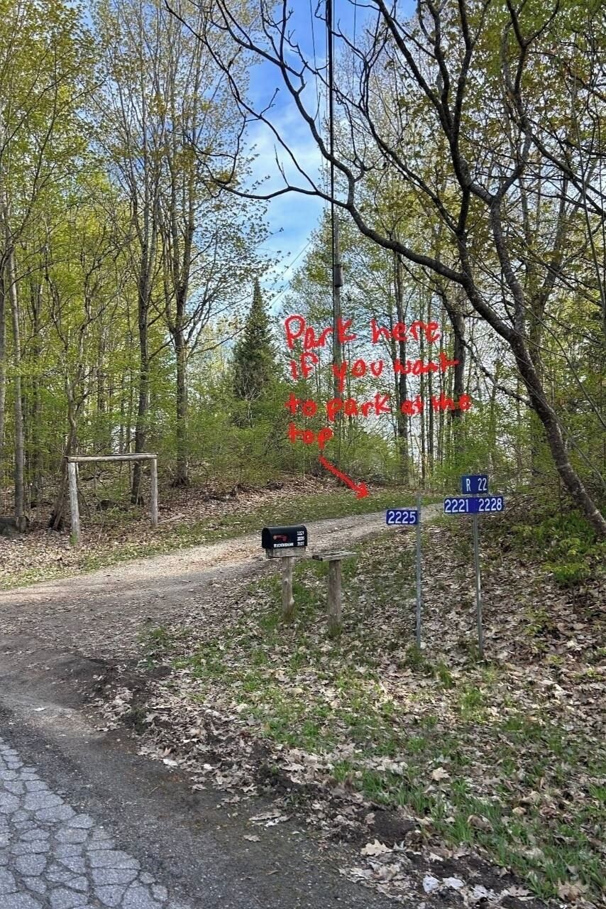A rural road with a mailbox and directional signs.