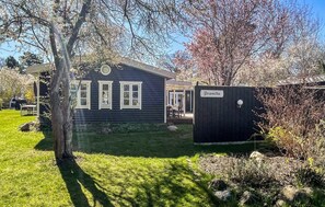 A house with a dark exterior, a visible porch, and a sign reading 'promilla'. - Amazing home in Vig with WiFi (Vig)
