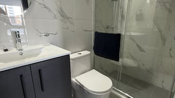 Luxury Apartment, City View | Bathroom | Shower, hair dryer, slippers, towels