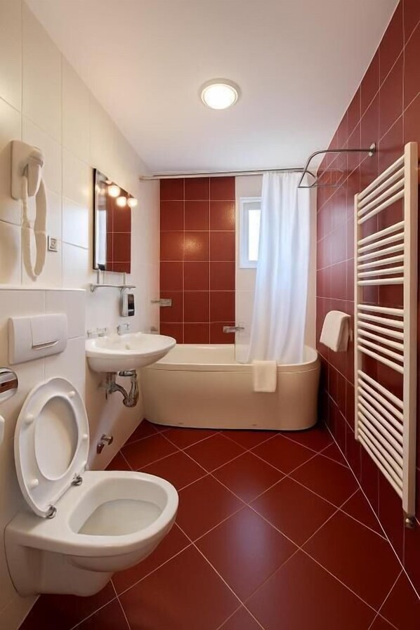 A bathroom with a toilet, sink, and bathtub.