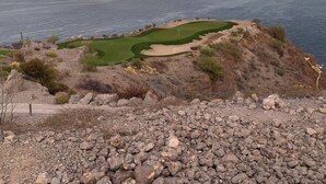 Un terrain accidenté avec un parcours de golf et une vue sur l’océan.
