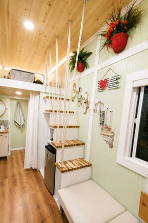 A room with a wooden ceiling, a bed, a small table, a sink, and a window. - Cozy Tiny RV Stay Near Disneyland, LA & Orange County (Rowland Heights)
