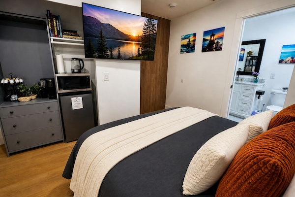 55” Smart TV with Netflix, high-speed Wi-Fi, mini fridge & microwave.