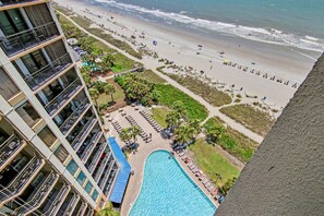 A high-rise hotel with a swimming pool, beach, and ocean view. - Oceanfront King Studio w/ Sleeper Sofa + Pools (Myrtle Beach)