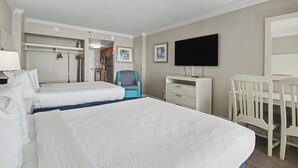 A hotel room with two beds, a desk, a chair, a television, and a bathroom visible through an open door. - Oceanfront Studio w/ Two Queens + Beach & Pools (Myrtle Beach)