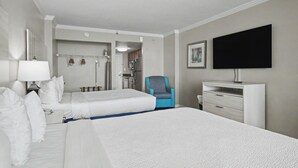 A hotel room with two beds, a desk, a chair, a TV, and a bathroom visible through an open door. - Oceanfront Studio w/ Two Queens + Beach & Pools (Myrtle Beach)