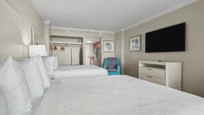 A hotel room with two beds, a TV, a desk, and a chair. - Oceanfront Studio w/ Two Queens + Beach & Pools (Myrtle Beach)