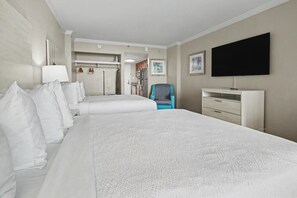 A hotel room with two beds, a TV, a desk, and a chair. - Oceanfront Studio w/ Two Queens + Beach & Pools (Myrtle Beach)