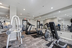A gym with cardio machines, weightlifting equipment, and mirrors. - Ocean View King Room + Beach Access + Lazy River (Myrtle Beach)