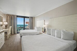 A hotel room with two beds, a desk, and a view of the ocean. - Oceanfront Studio w/ Two Queens + Beach & Pools (Myrtle Beach)