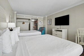 A hotel room with two beds, a TV, a desk, and a chair. - Oceanfront Studio w/ Two Queens + Beach & Pools (Myrtle Beach)