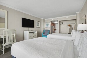 A hotel room with two beds, a desk, a chair, a television, and a bathroom visible through an open door. - Oceanfront Studio w/ Two Queens + Beach & Pools (Myrtle Beach)