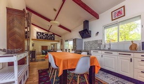 A kitchen with a dining table, chairs, and a window with a view. - Les Amandiers - CEYRAT (CEYRAT)