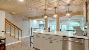A kitchen with wooden ceiling, pendant lights, a stainless steel dishwasher, and a coffee maker. - Summit View - Mountain Top View & Gas Fireplace (Hiawassee)