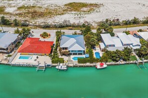 An aerial view of a coastal property with multiple buildings, a dock with boats, and a swimming pool. - Waterfront Marathon FL Home w/ Pool, 75' Dock, Near Sombrero Beach, Pet Friendly (Marathon)
