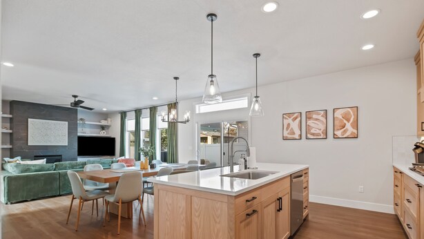 A modern kitchen with a central island, wooden cabinets, and pendant lighting. - Pro Golf Simulator and Hot Tub, New Luxury 4 BR, Boise Home Sleeps 12 (Boise)