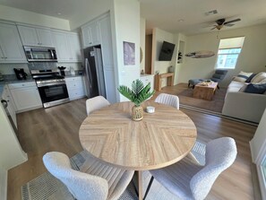 A modern kitchen with white cabinets, a built-in oven, and a refrigerator. - Walk to the Beach. Nest on a Doorstep of Coronado. 2-Bedroom Townhome (Imperial Beach)