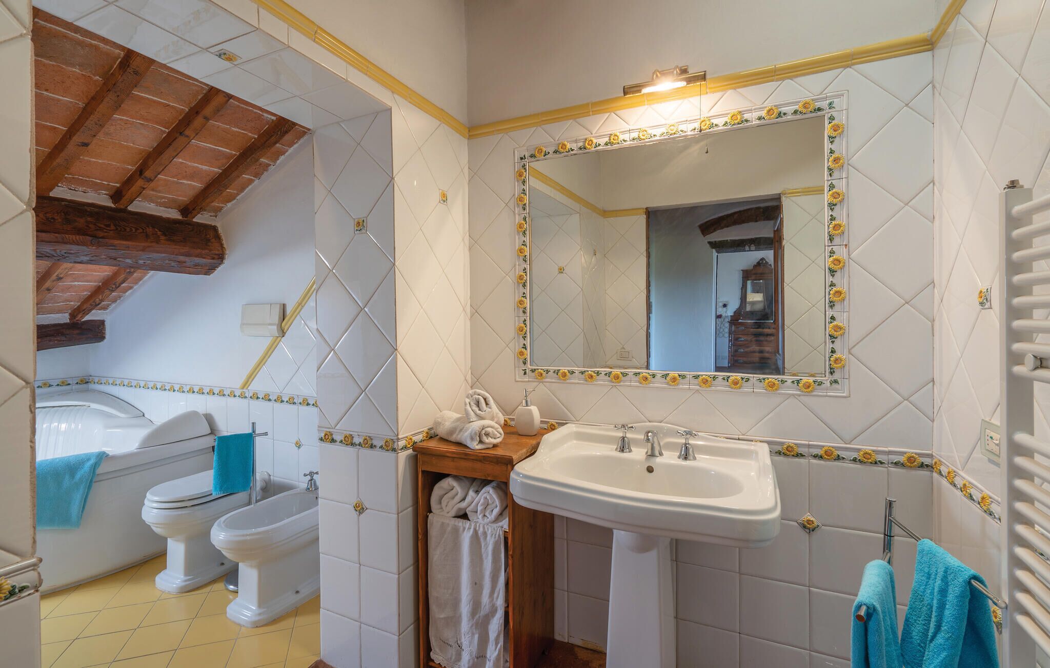 A bathroom with a bathtub, toilet, bidet, and sink.