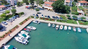 A marina with boats docked, surrounded by residential buildings with red roofs. - Apartment Sally by Interhome (Krk/Čižići)