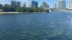 A coastal cityscape with high-rise buildings, a clear blue sky, and calm water. - My Time Boat House, Coconut Grove Miami (Miami)