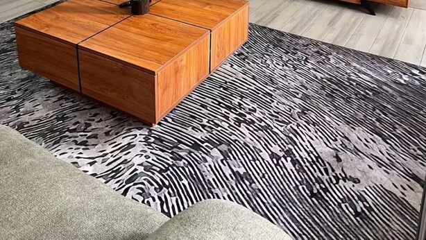 A modern living room with a wooden coffee table, a black sofa, a TV displaying a fire, and a wooden cabinet. - Unimash Homes Kenya W/SwimmingPool Available For Long/Short Term Stays (Nairobi)