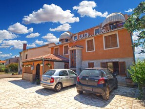 A two-story house with a stone facade, a tiled roof, and two cars parked in the driveway. - Apartment 709 by Interhome (Fažana)