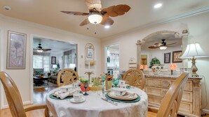 A dining room with a round table, chairs, and a ceiling fan. - Peaceful Porch, Yard! Riverdale Home Near Dtwn ATL (Riverdale)