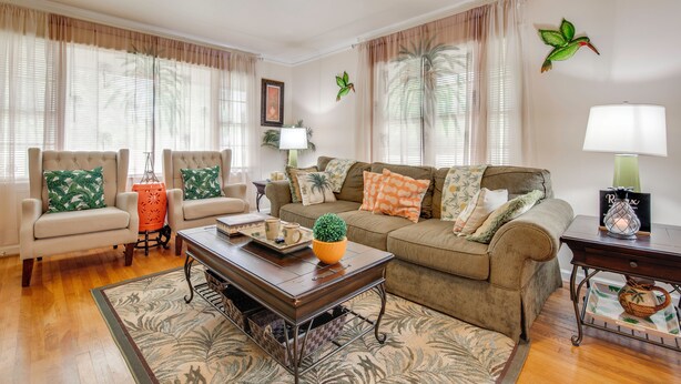 A living room with a sofa, armchairs, a coffee table, and a lamp. - Peaceful Porch, Yard! Riverdale Home Near Dtwn ATL (Riverdale)