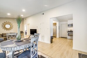A dining area with a round table, chairs, a vase, and a television. - 14 Mi to Mercedes-Benz Stadium! Home w/ Yard (Decatur)