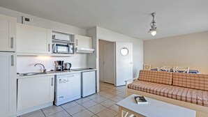 A compact kitchen with a microwave, coffee maker, and a small refrigerator. - Beach Flat with Pool (Plougonvelin)