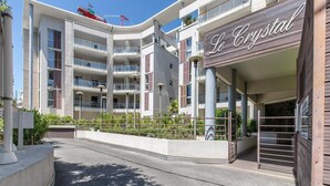 A multi-story hotel with balconies, a gated entrance, and a sign reading 'Le Crystal.' - Coastal Stay for 4 in Cagnes-sur-Mer (Cagnes-sur-Mer)
