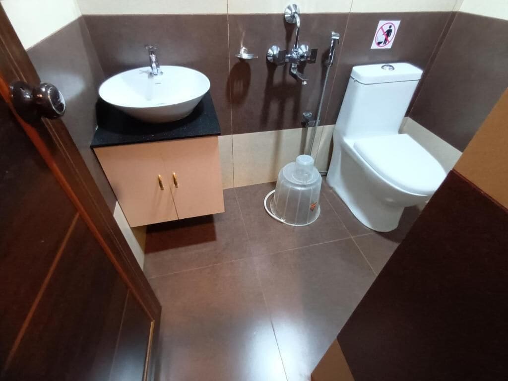 A bathroom with a sink, toilet, and shower.