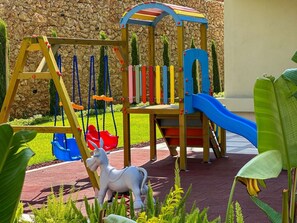 A playground with a swing set, slide, and climbing area. - Qoople Eхсellence B-11 neue Wohnung am Meer by Interhome (Alanya)