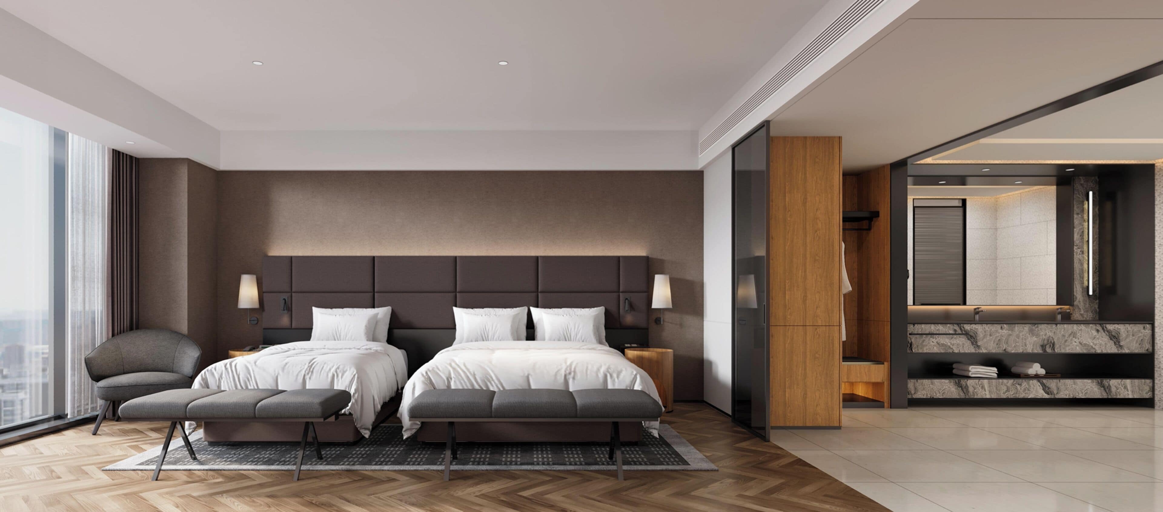 A modern hotel room with a large bed, a seating area, a bathroom with a marble vanity, and a city view.