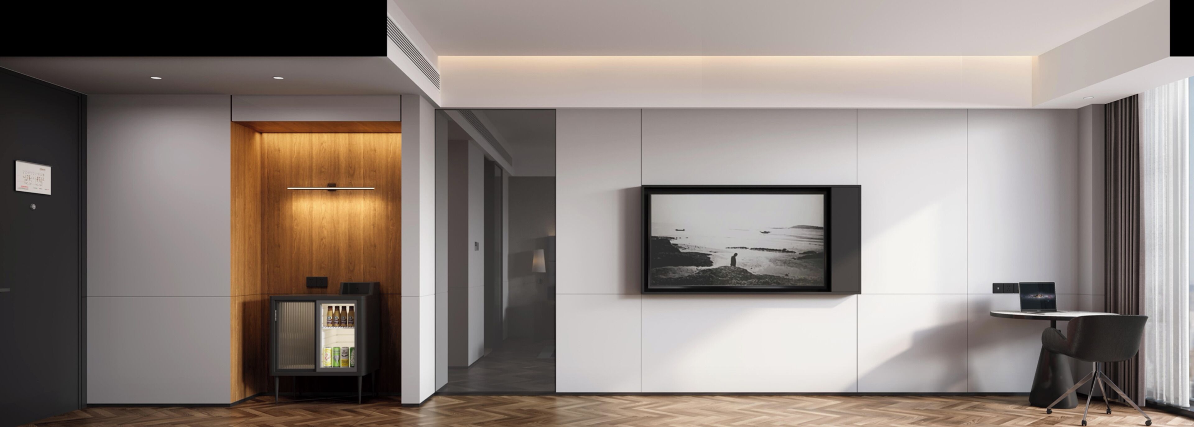 A modern hotel lobby with a wooden cabinet, a framed photograph, and a small table with a laptop.