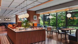 A modern dining area with a central island, large windows, and a patterned floor. - Songshan Lake Intercity Hotel (Dongguan)