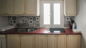 A kitchen with two sinks, a window, and patterned backsplash. - P Andaluz 670 by At Home Costa del Sol (Torrox)