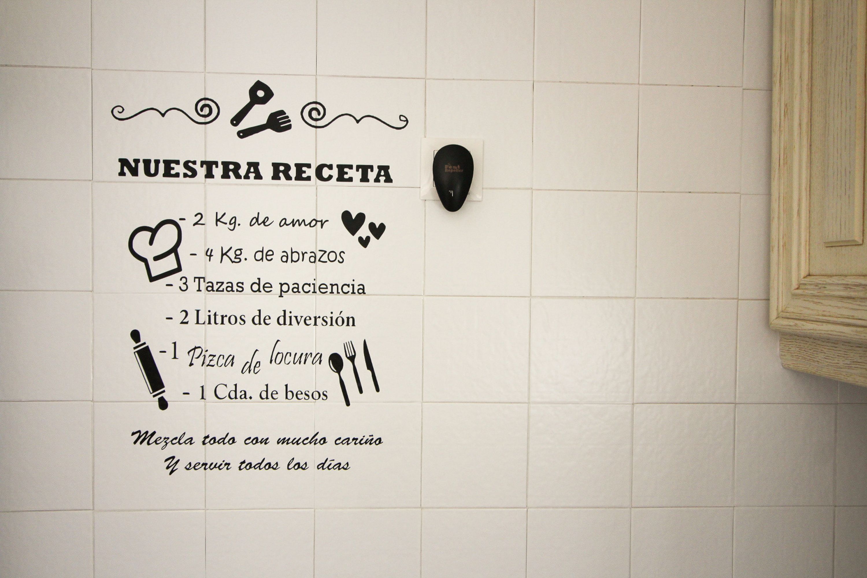 A wall with a recipe list including ingredients like love, hugs, patience, wine, pizza, and bread.