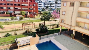 A residential building with a swimming pool, a pergola, and a well-maintained garden. - Albatros 1 by At Home Costa del Sol (Algarrobo)