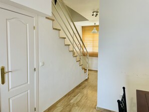 A staircase with a handrail and a light fixture above it. - Albatros 3 by At Home Costa del Sol (Algarrobo)