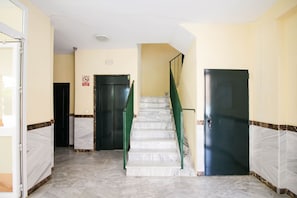 A hallway with a marble staircase, two black doors, and a 'No Smoking' sign. - Albatros 3 by At Home Costa del Sol (Algarrobo)